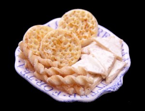 Buttered bread, crumpets and cheese straws